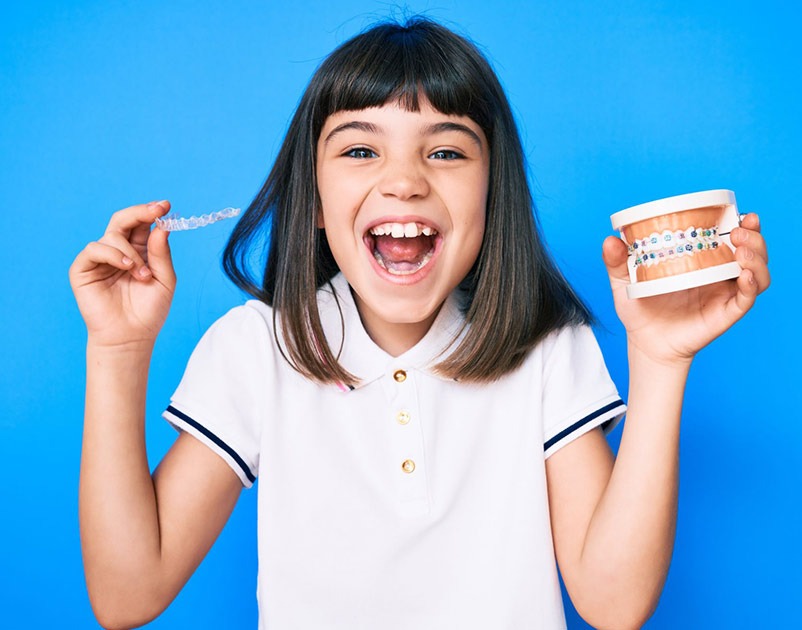 young-girl-holding-aligner