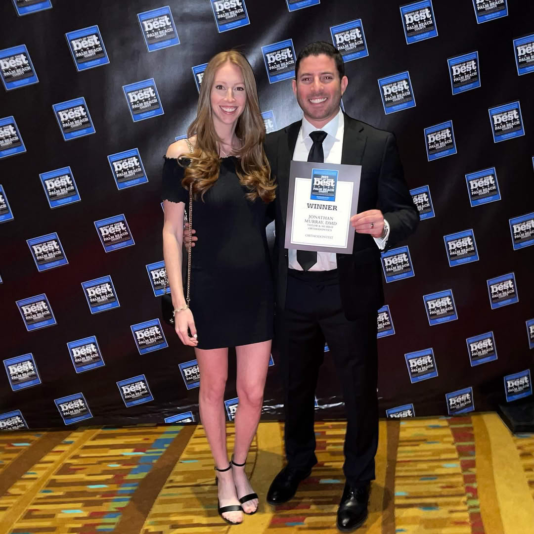 Dr. Jonathan Murray at the Best of Palm Beach County awards ceremony holding his Best Orthodontist winner plaque