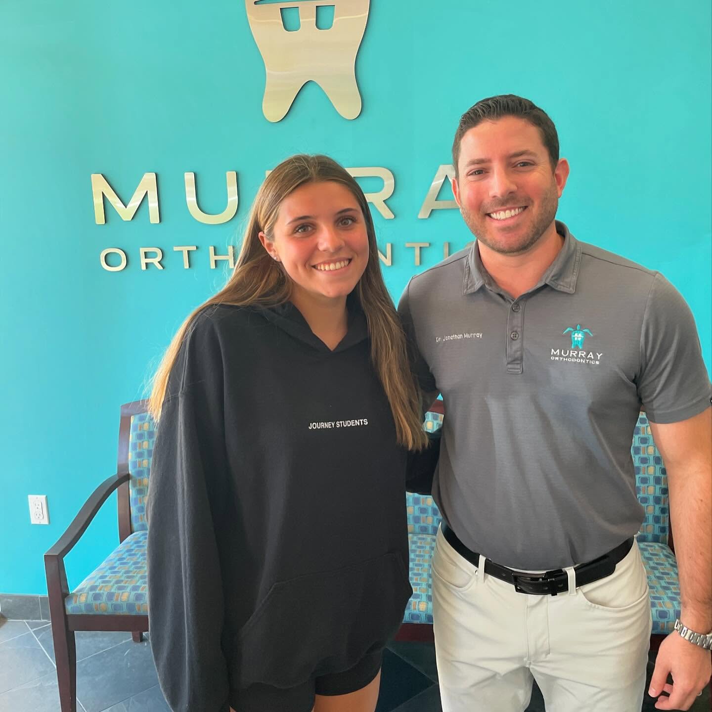 Patient smiling with Dr. Jonathan Murray after completing orthodontic treatment at Murray Orthodontics in Palm Beach Gardens