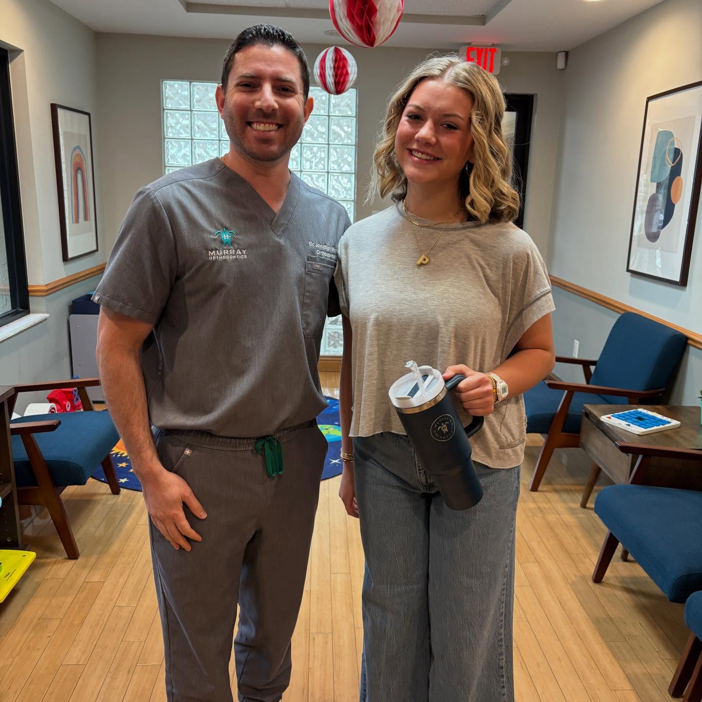 Dr. Jonathan Murray with teen patient on the day her braces came off at Murray Orthodontics after crossbite treatment in Palm Beach Gardens
