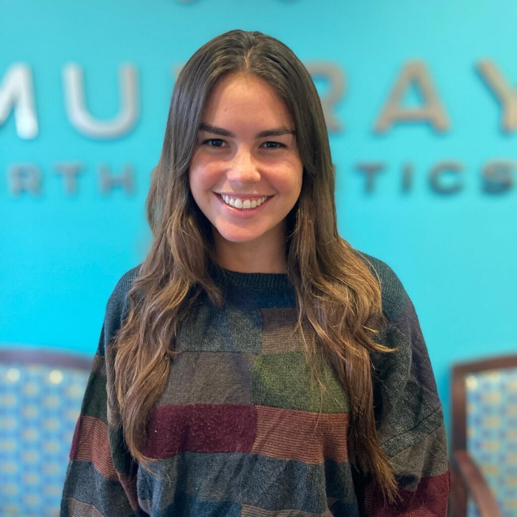 Rainey M. smiling after completing her Invisalign treatment at Murray Orthodontics in Palm Beach Gardens