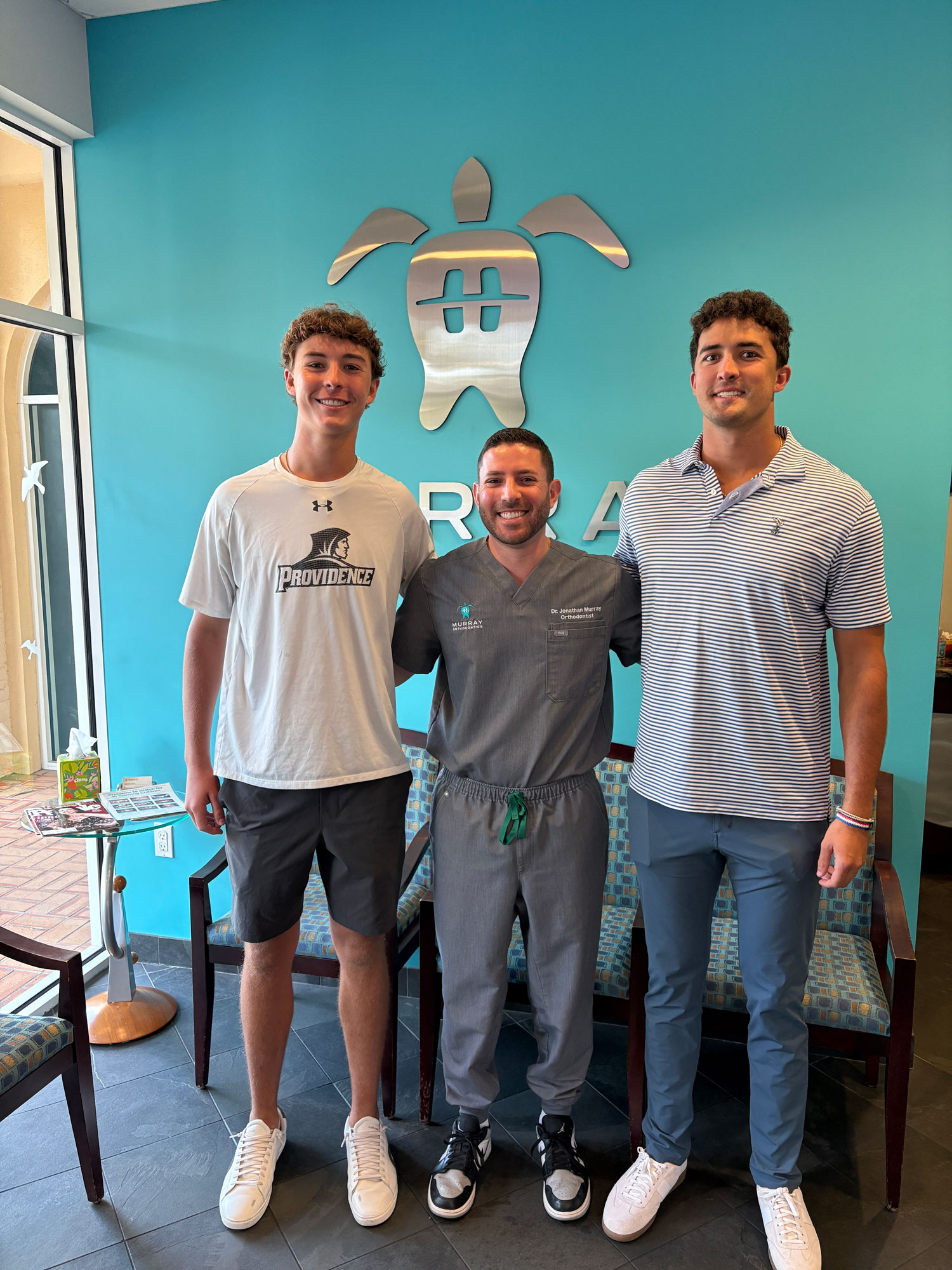 Dr. Jonathan Murray with two college-bound patients at his Palm Beach Gardens orthodontic office