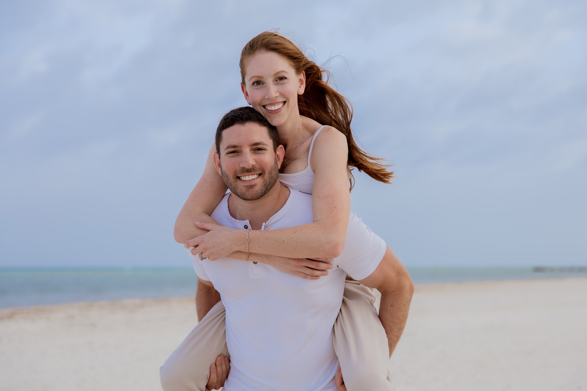 Dr. Jonathan Murray, Palm Beach Gardens orthodontist, laughing with his wife Allie on a South Florida beach