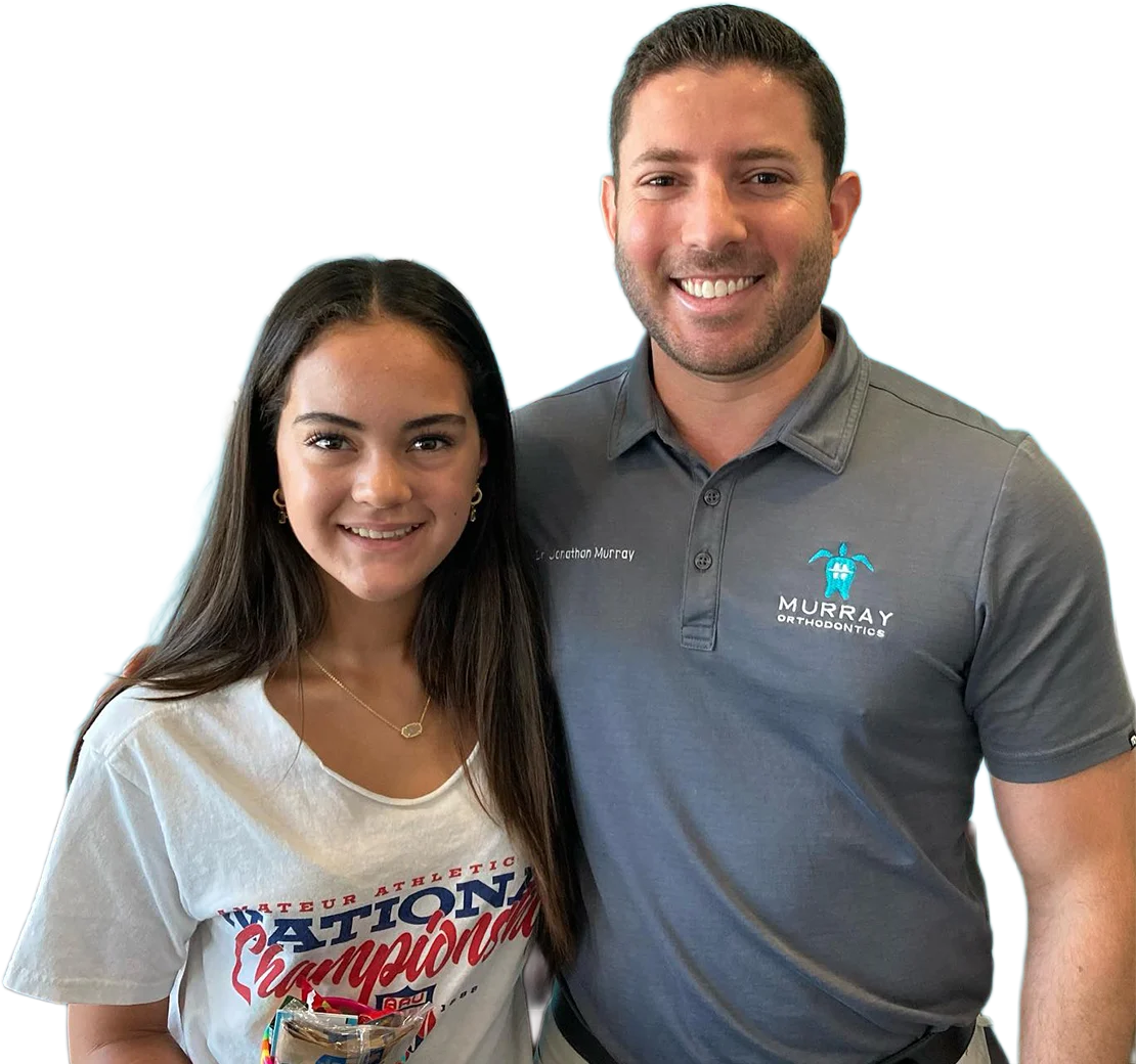 Dr. Murray, Board-Certified Orthodontist, smiling with a young braces patient at Murray Orthodontics in Palm Beach Gardens
